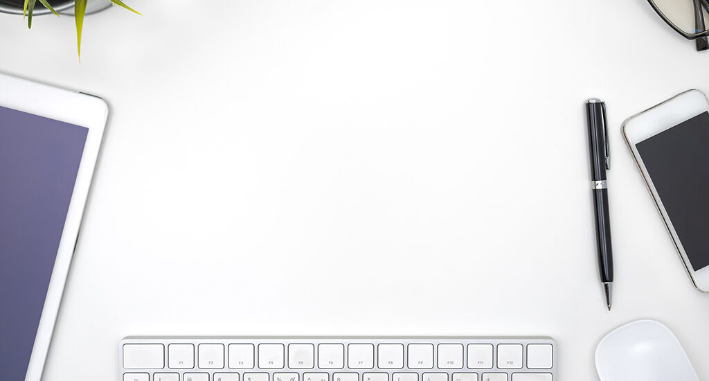 Frame with office equipment on white desk with copy space, flat lay style