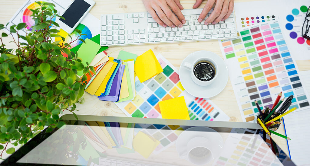 Hands of male graphic designer using computer in office